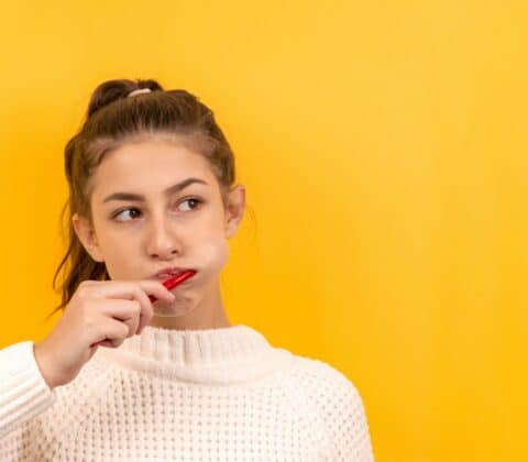 girl brushing braces teeth