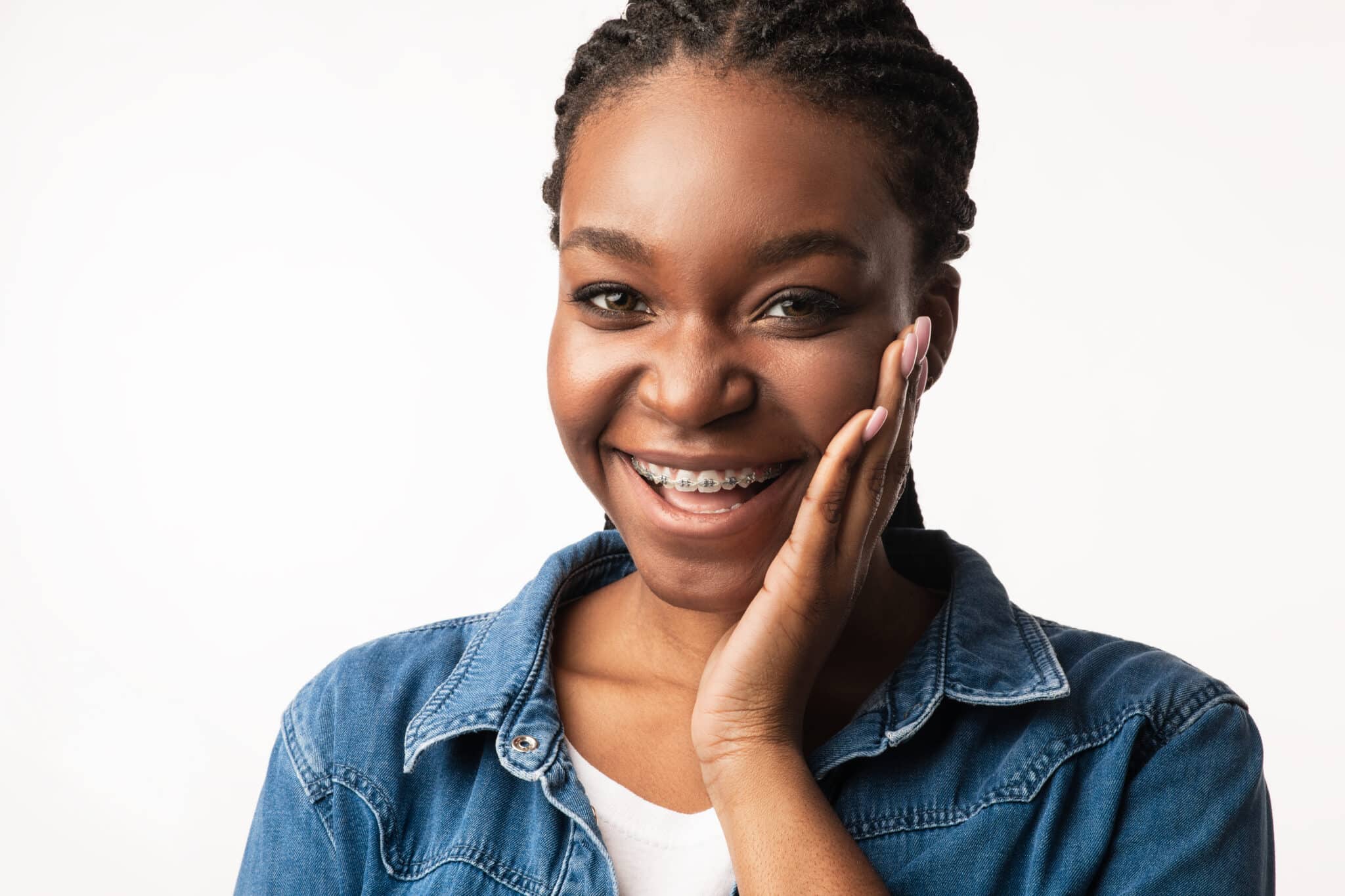 happy african american lady with braces posing on white background